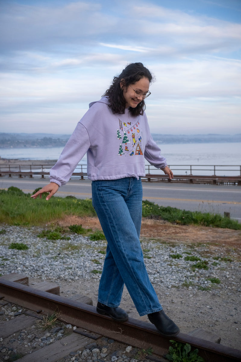 Woman walking on a railway track by a coastal area